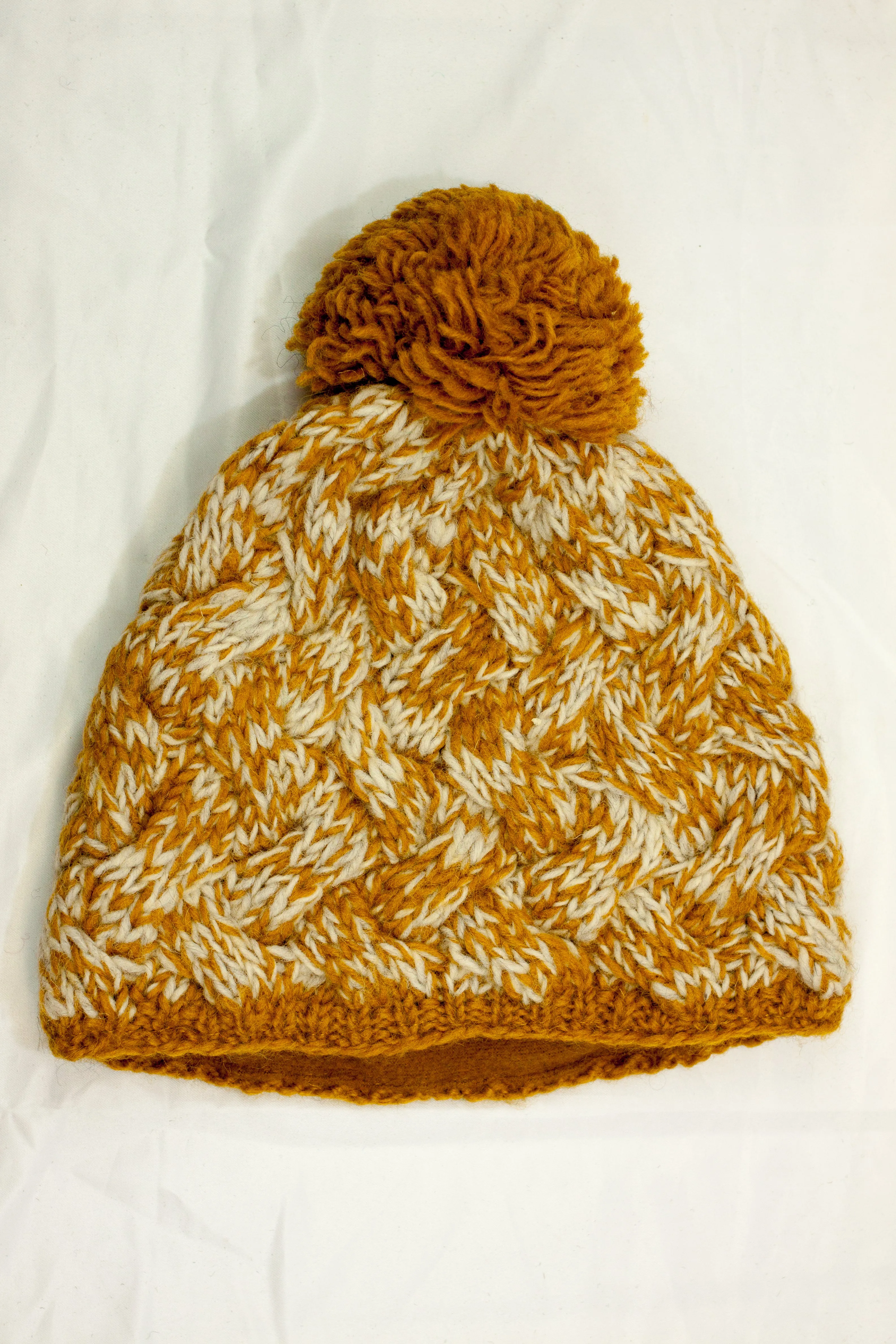 Hand knitted woolen pom pom beanie with soft fleece liner - unisex