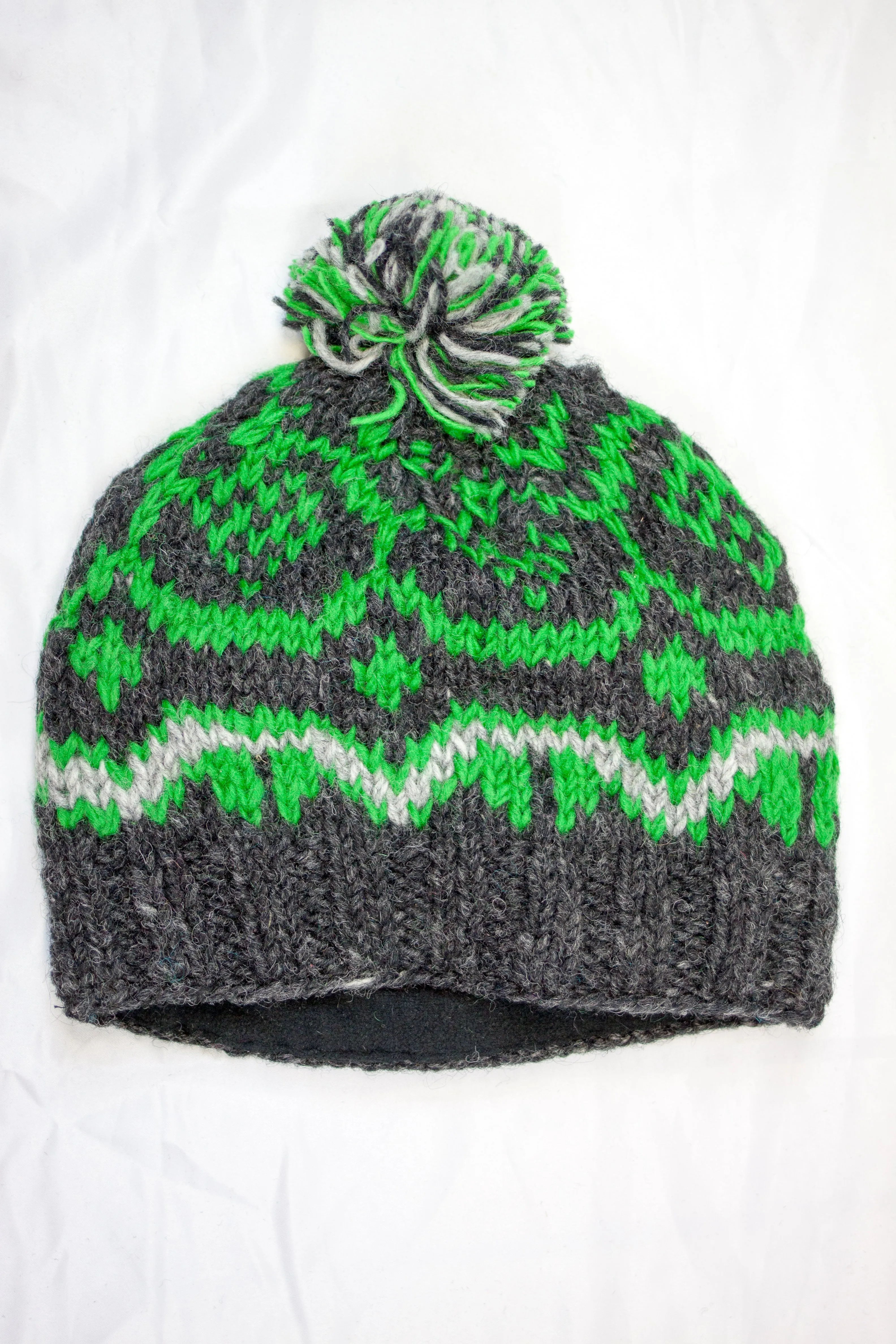 Hand knitted woolen pom pom beanie with soft fleece liner - unisex