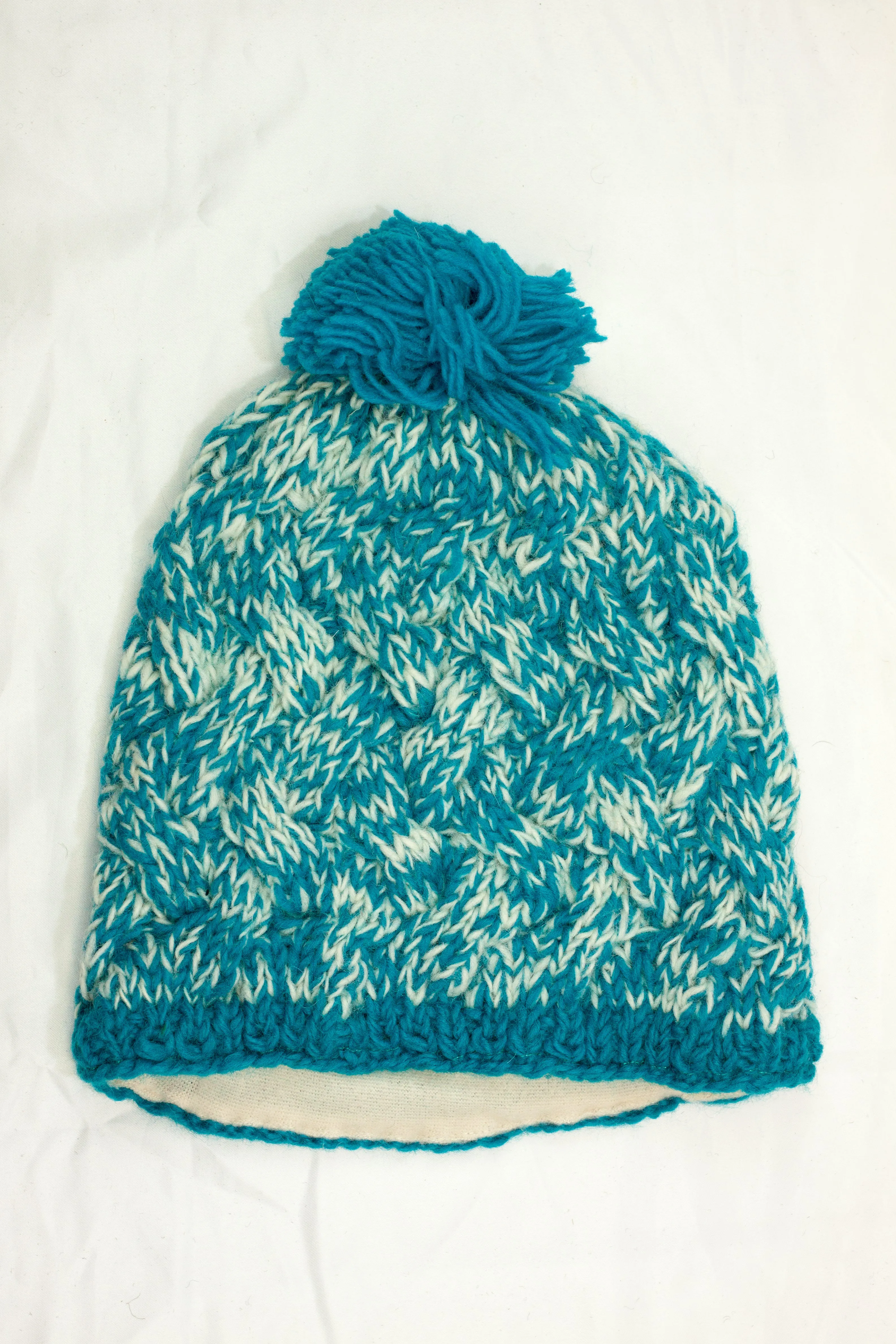 Hand knitted woolen pom pom beanie with soft fleece liner - unisex